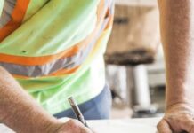 A construction worker goes over plans