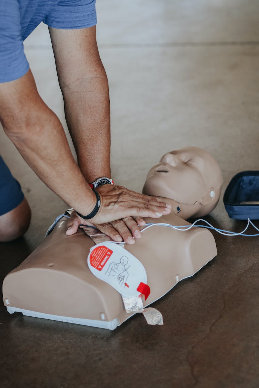 hands of person doing cpr on training dummy