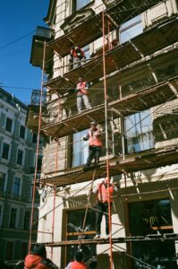 men on brown scaffolding