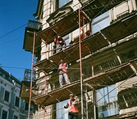 men on brown scaffolding