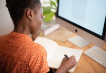 woman writing on her notebook