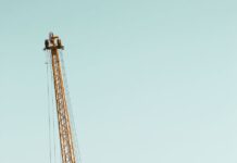 black and yellow crane on ship