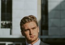 elegant young bearded businessman in suit and tie in downtown