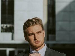 elegant young bearded businessman in suit and tie in downtown