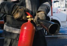 firefighter holding fire extinguisher