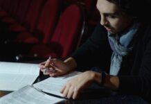 man reading and reviewing some papers