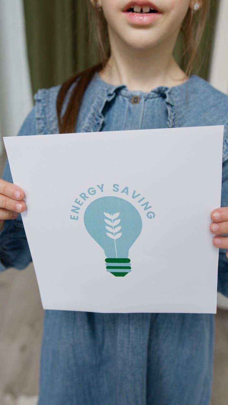 crop photo of a girl holding a slogan on energy saving