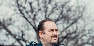 policeman standing near bare trees