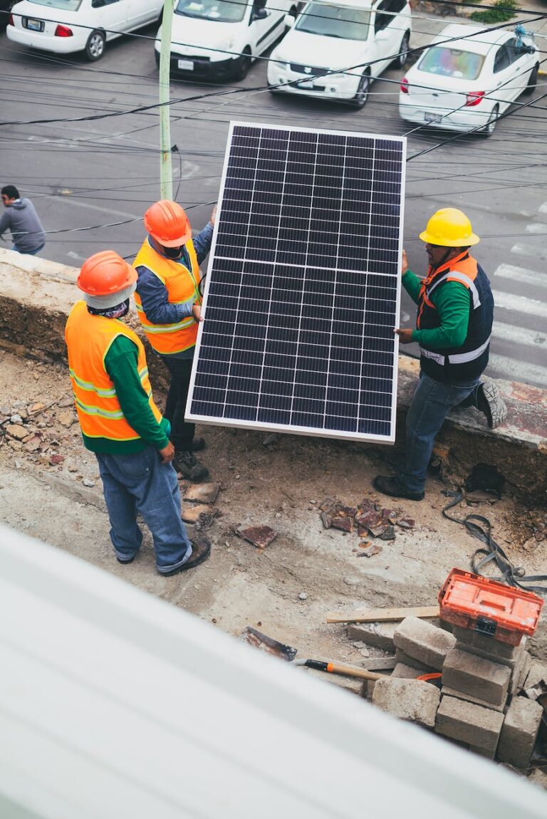 solar technicians carrying solar panel