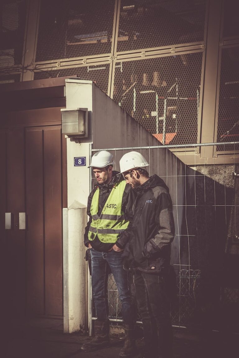 two men wearing white hard hat