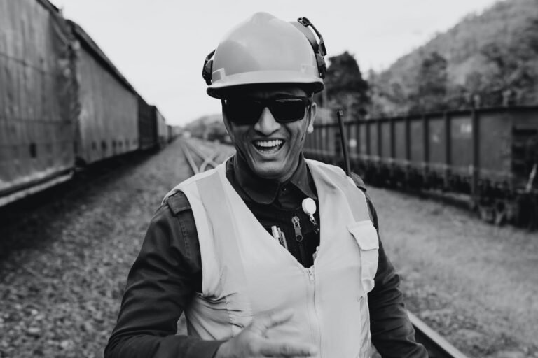 monochrome portrait of a smiling railroad worker