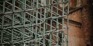 two person on truss tower