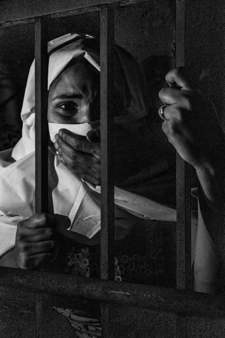 grayscale photography of woman inside jail
