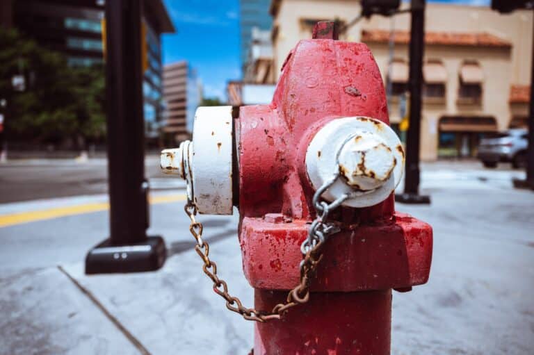 metal fire hydrant on city street against blue sky