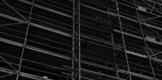 grayscale photo of scaffolding outside a building