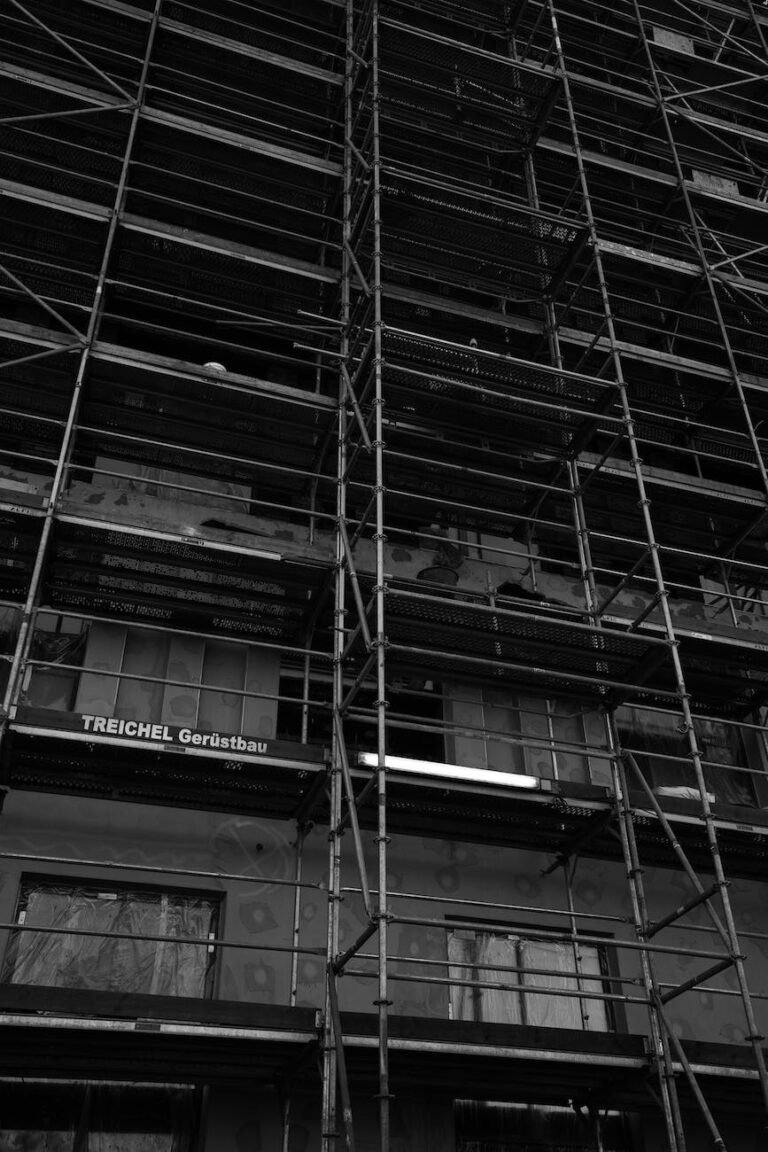 grayscale photo of scaffolding outside a building