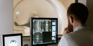 photo of doctor looking deeply unto the screen