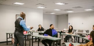 teacher giving the test results to his students