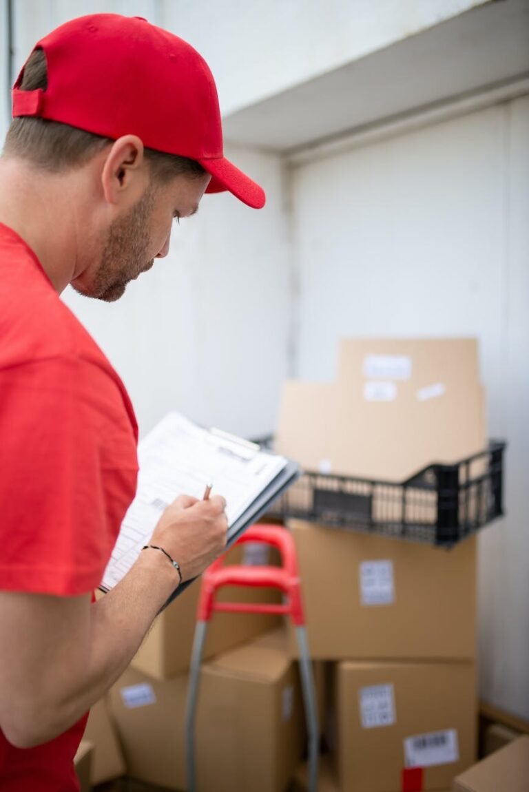 man in red t shirt holding white printer paper