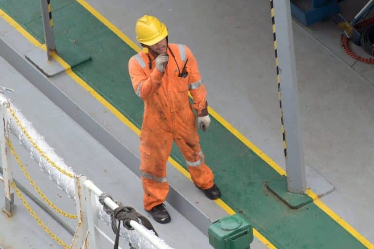 worker in uniform and helmet on road