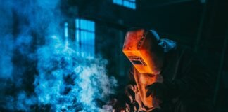 person welding wearing a prootective metal mask