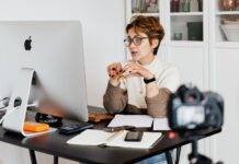 confident elegant lady in eyeglasses hosting webinar