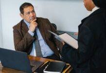 focused diverse coworkers discussing business project in office