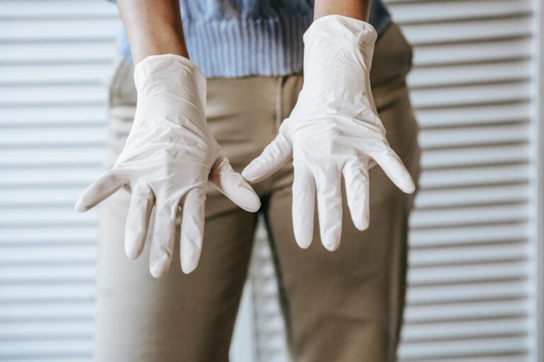 crop woman in latex gloves