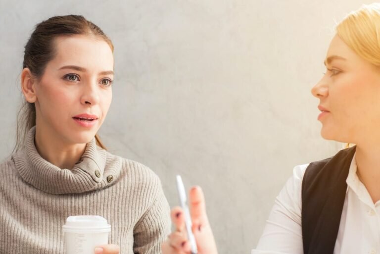 two women holding pen