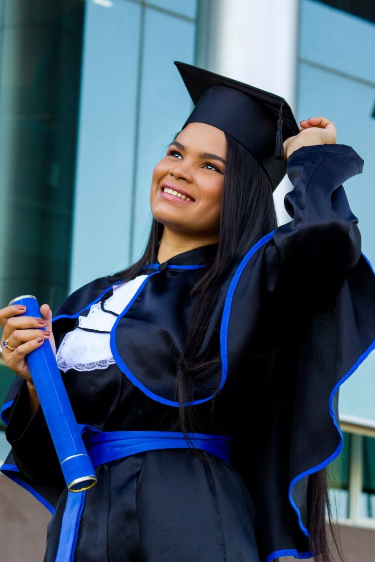 cheerful latin american woman in graduation outfit