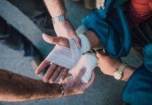 person applying bandage on another person s hand