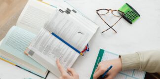 person studying and writing notes on paper