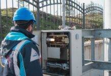 an electrician inspecting a fuse box