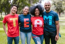 group of people wearing shirts spelled team