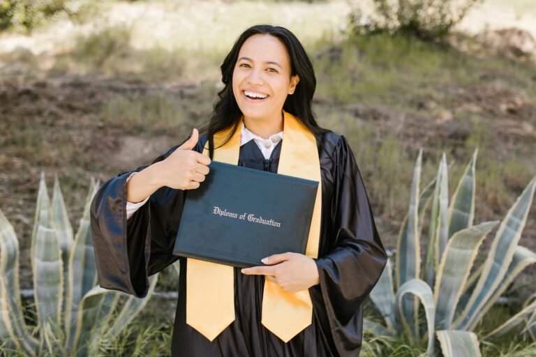 a woman in academic dress holding a diploma