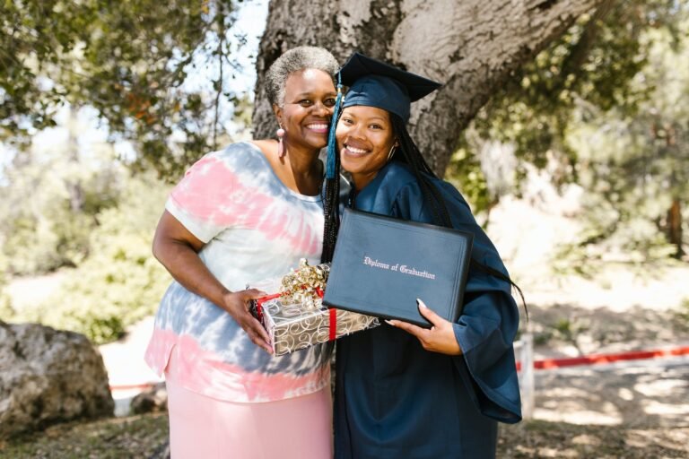 gray haired woman smiling beside the newly graduate student