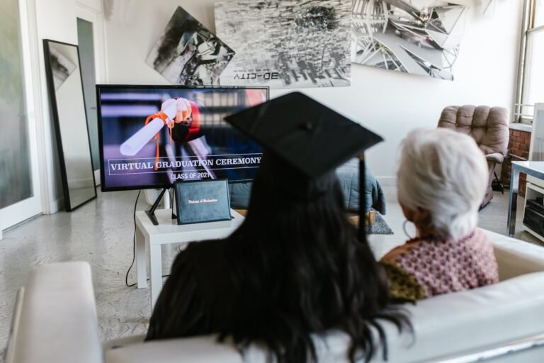 a person wearing graduation cap attending virtual graduation ceremony with an elderly