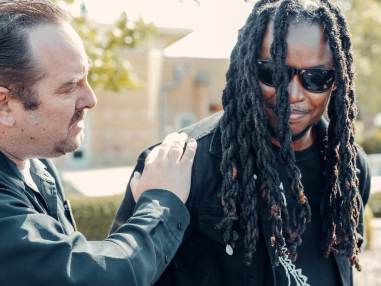 police officer arresting man in black shirt