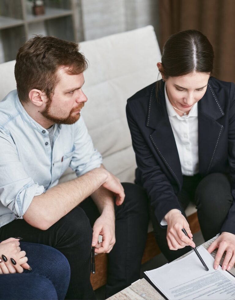 a woman in black suit explaining details of the document