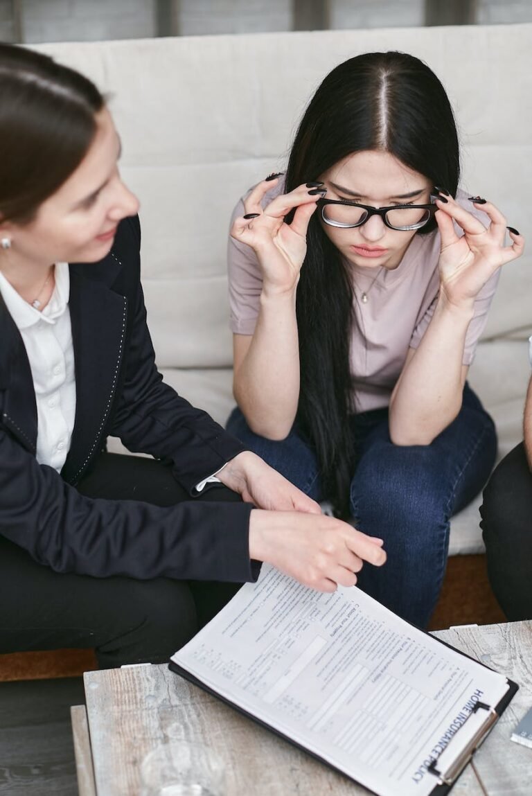 a woman wearing eyeglasses looking at a document