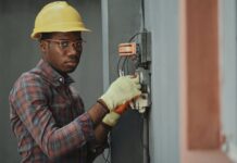 an electrician repairing a fuse box