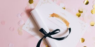 rolled white paper with ribbon on a certificate