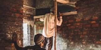 men working on the brick wall