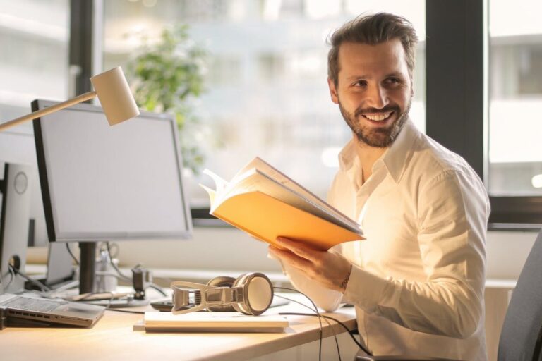 photo of man holding a book