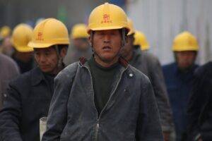 group of persons wearing yellow safety helmet during daytime