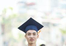 man in toga holding diploma