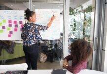 two women having a meeting inside glass panel office