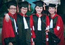 man and women wearing red and black academic gowns and black mortar boards