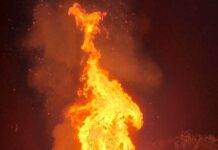 flame of a large bonfire burning at night