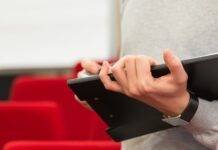 close up of man holding folder in hands